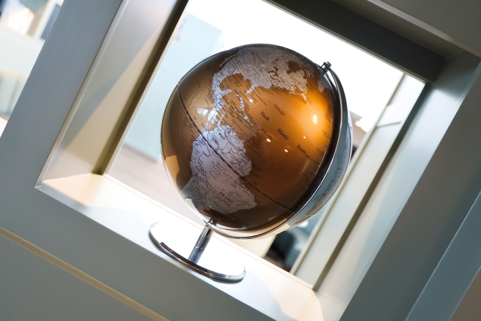 Brass globe on a studio shelf