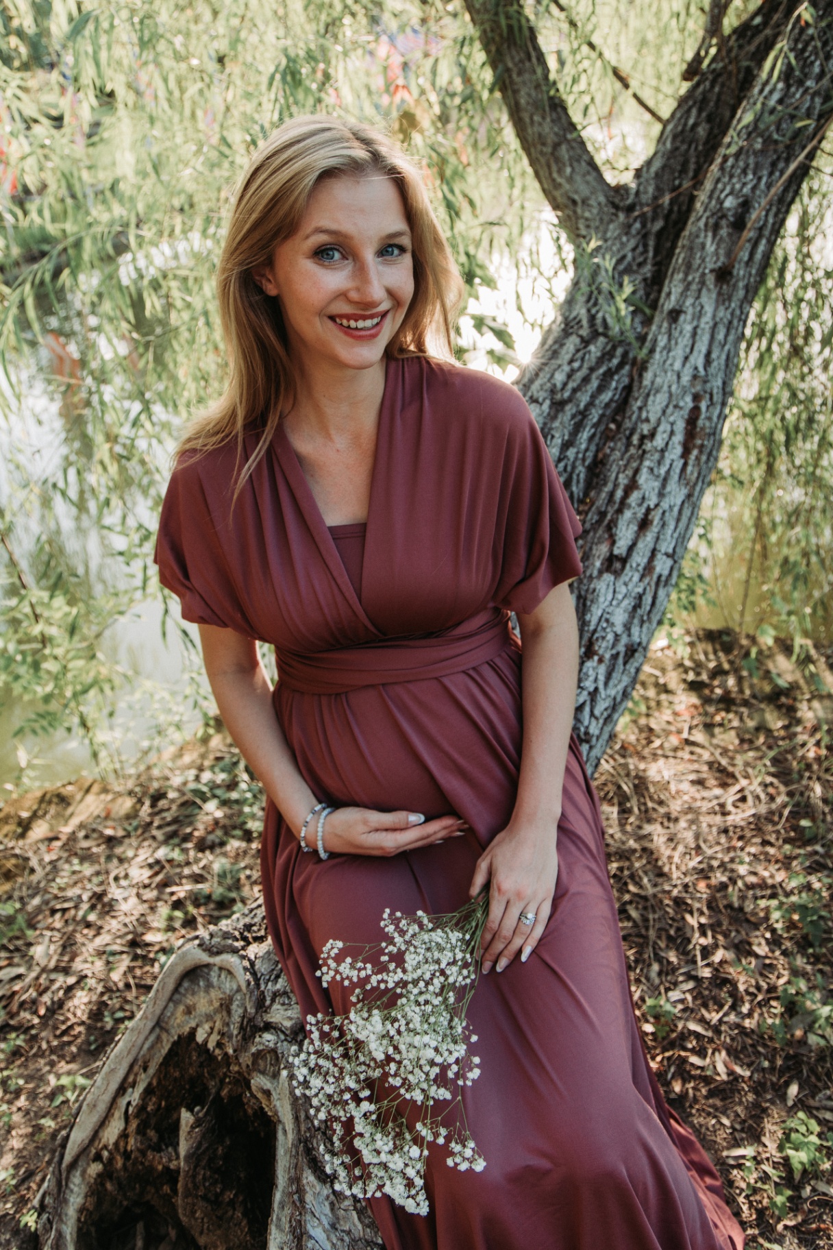 Naomi laughing under a willow by the water