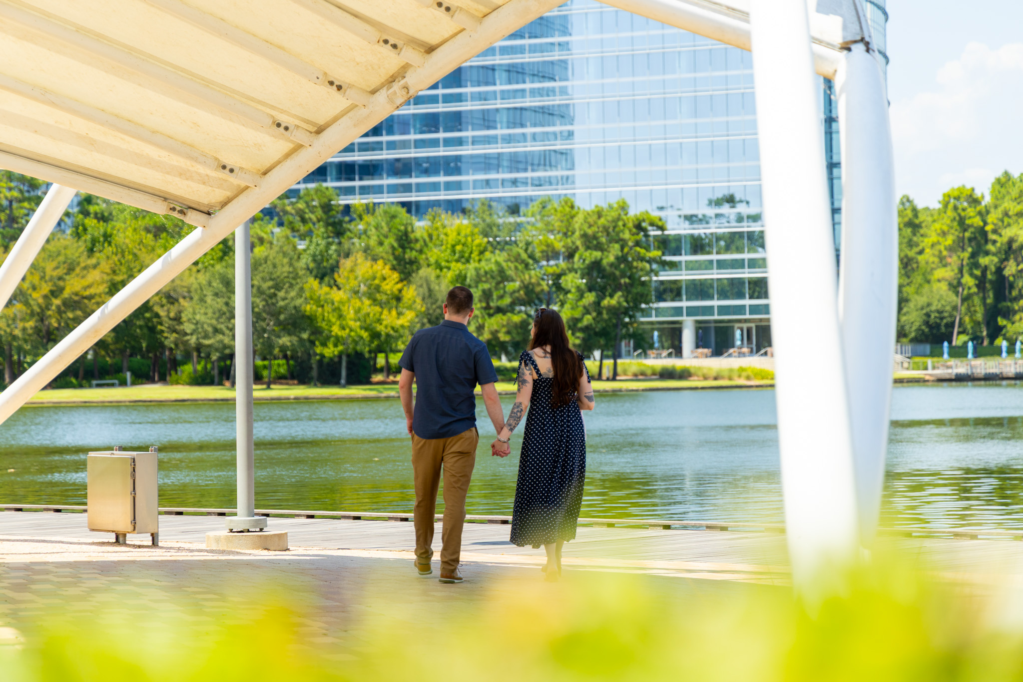 Brandon and Emily walking together beside the water
