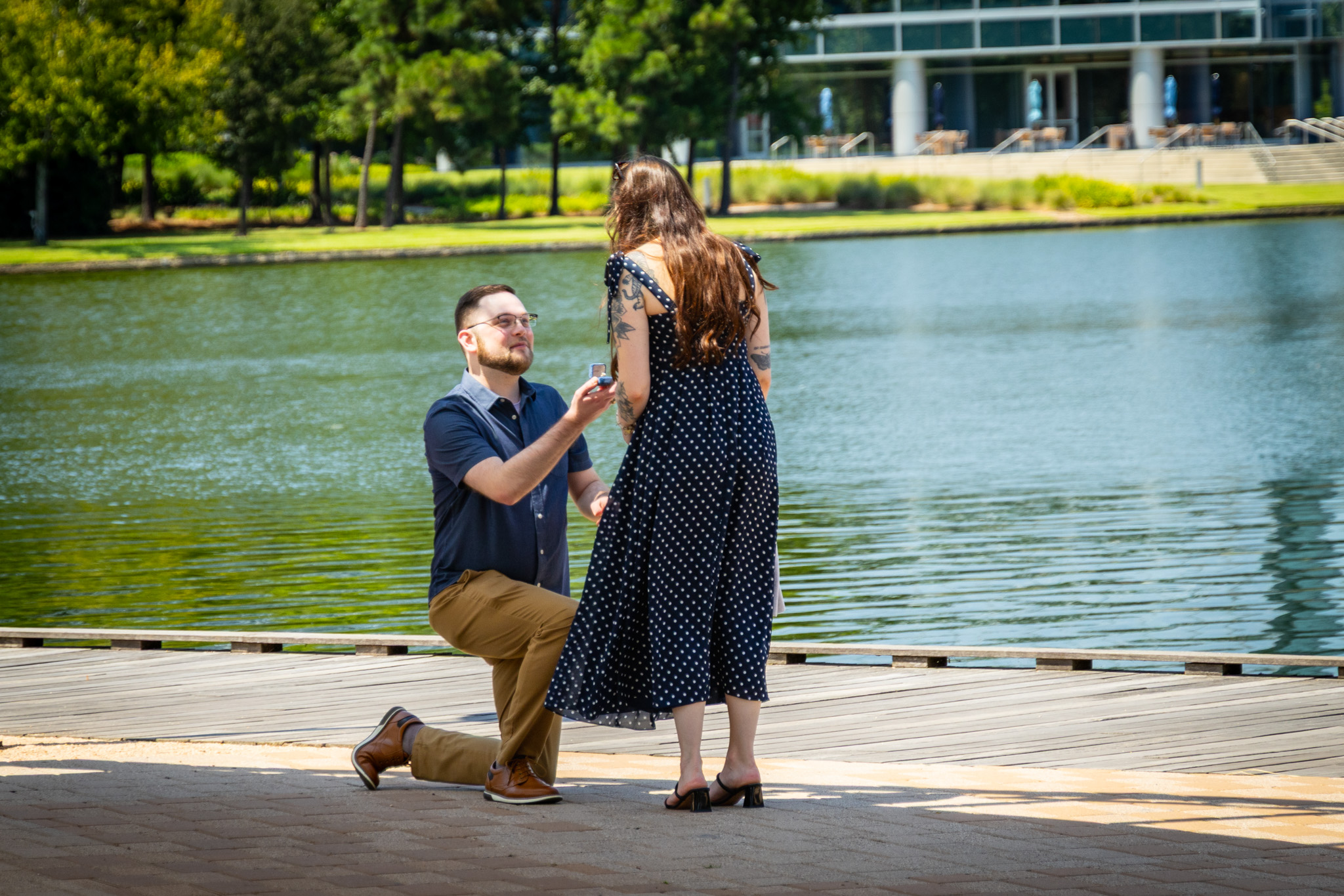 Brandon and Emily sharing a proposal moment by the water
