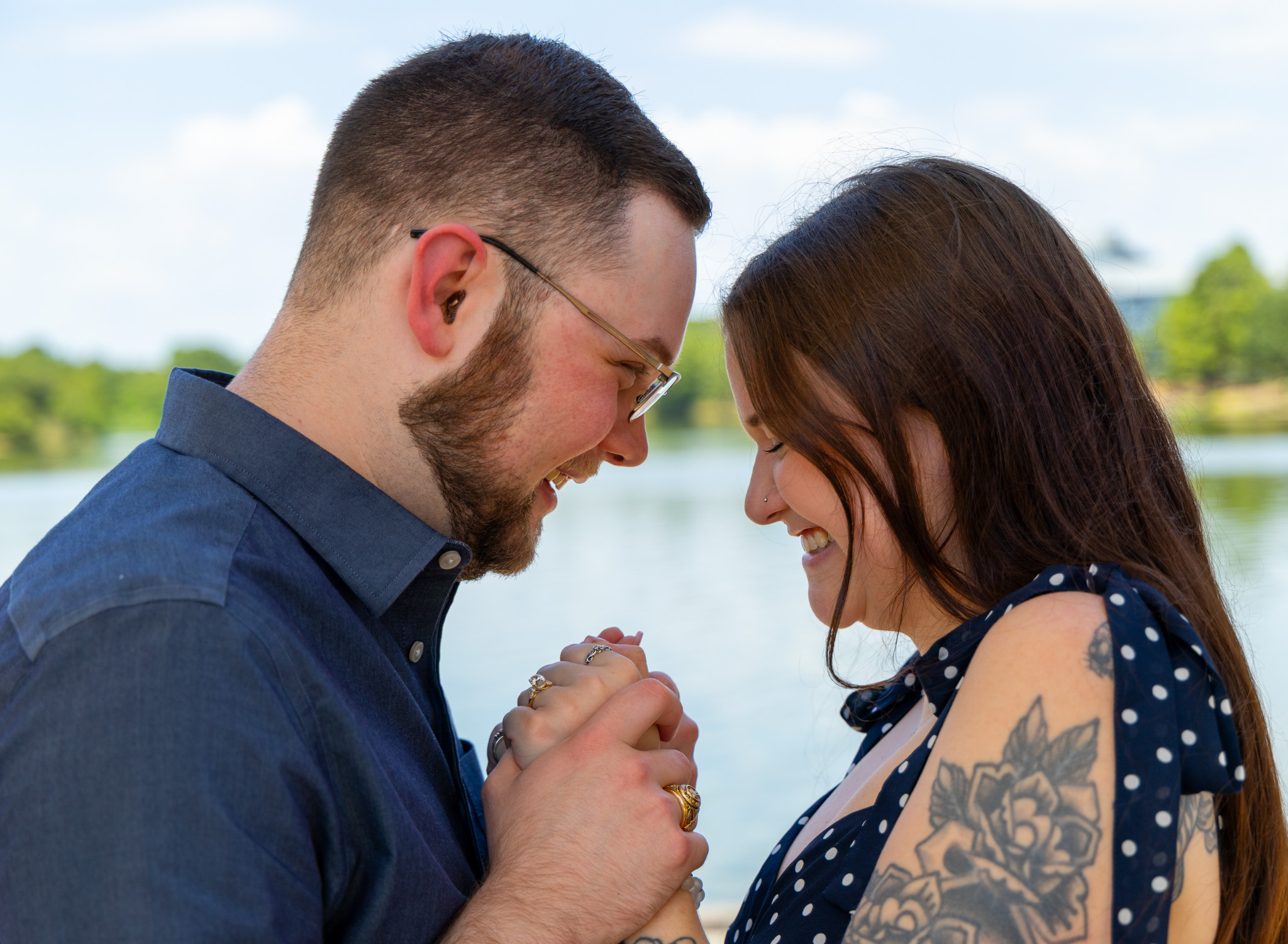Brandon and Emily smiling together by the water